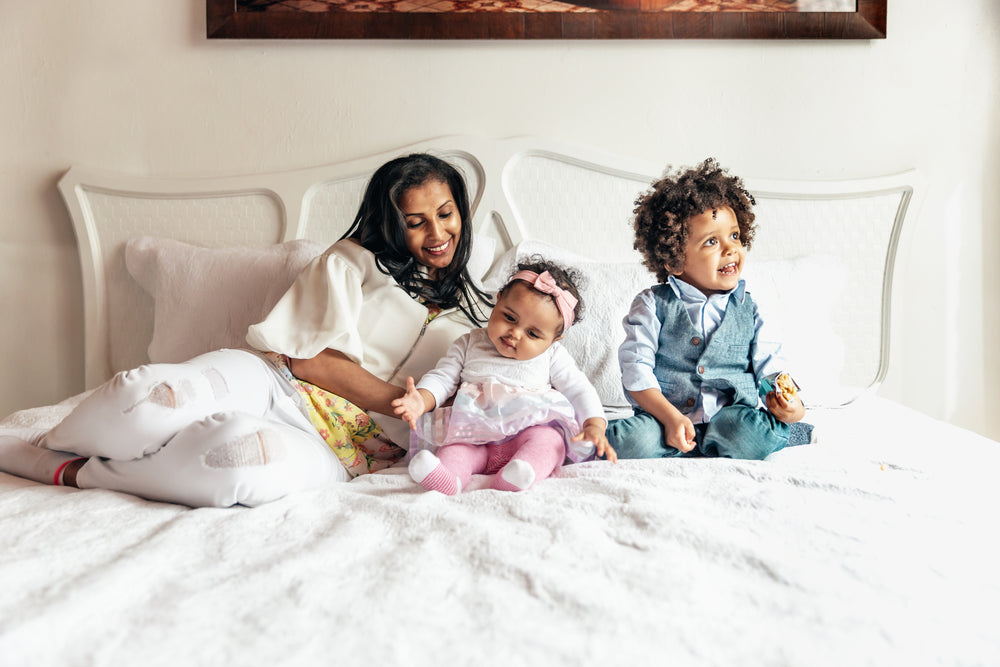 mom-with-daughter-and-son-on-bed